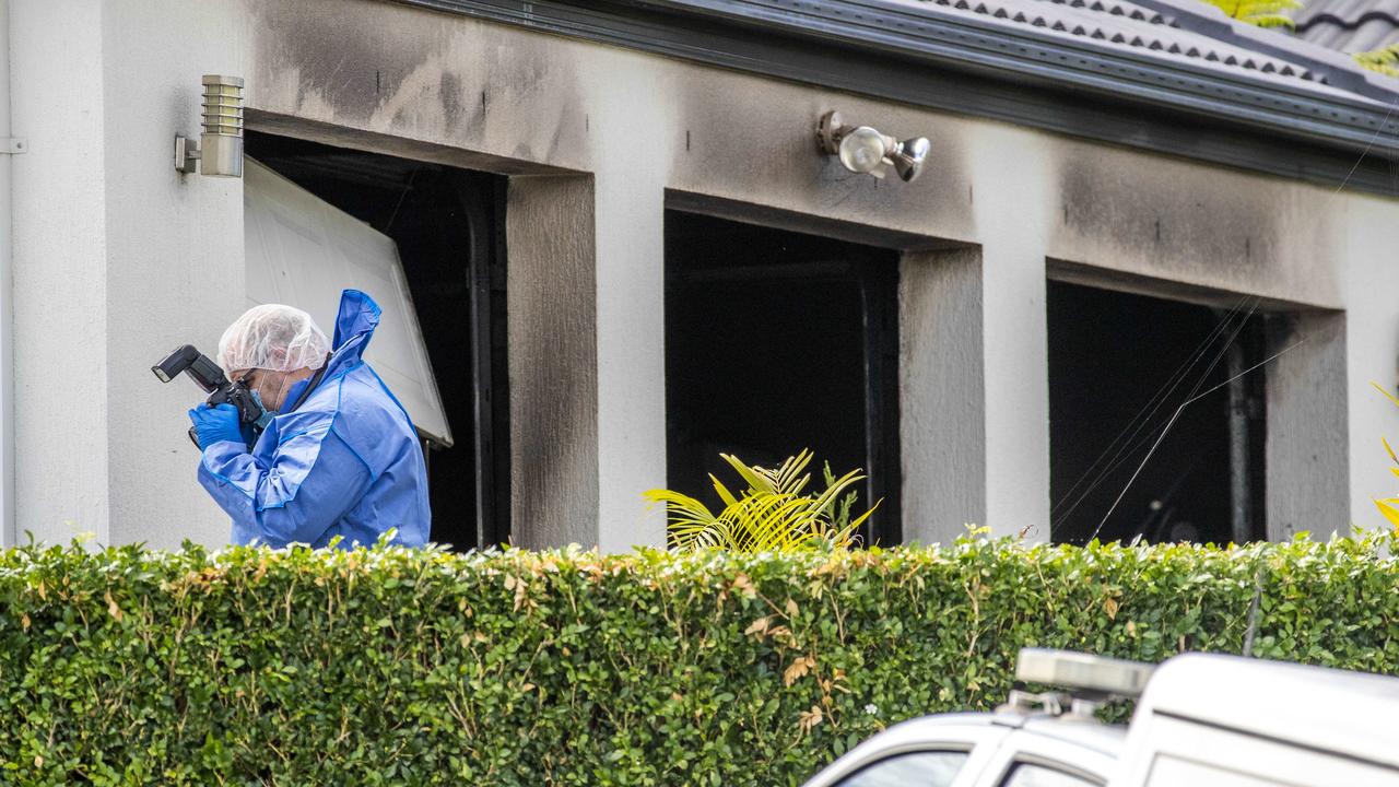 A forensic police officer at the Collingwood Park home on Sunday. Picture: Richard Walker