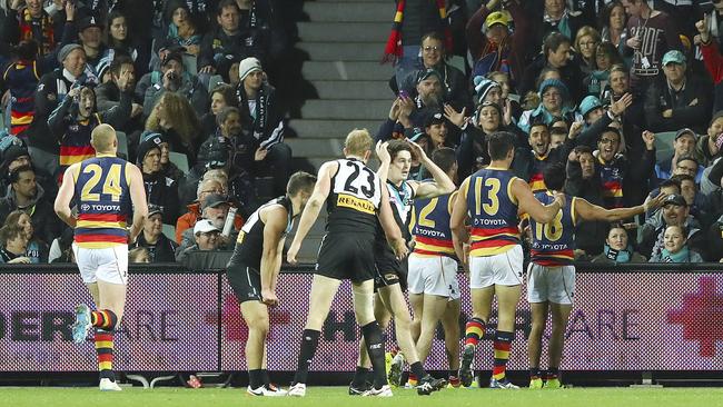 Brad Crouch and Taylor Walker run towards Eddie Betts after he kicked the sealer in Showdown 41. Picture: Sarah Reed