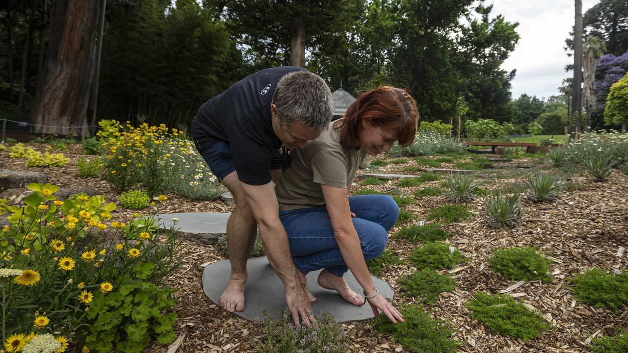 Megan and Joel O’Brien walk barefoot through the new sensory garden. Picture: NCA NewsWire/Daniel Pockett