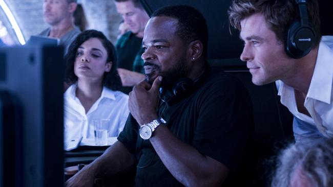 Tessa Thompson, director F. Gary Gray and Chris Hemsworth watch playback on the set of Men In Black: International.