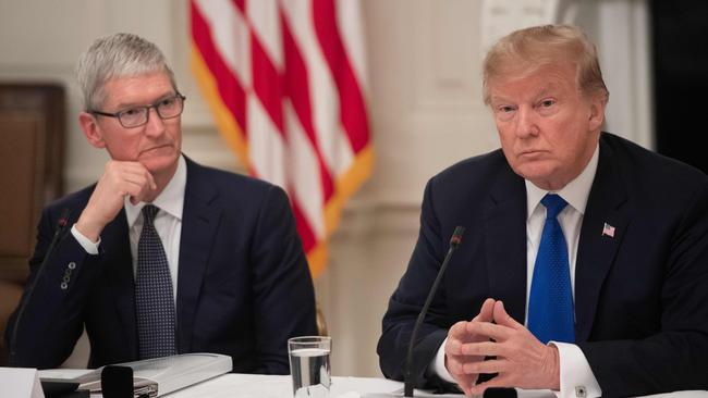 Apple CEO Tim Cook (left) and US President Donald Trump speak during the first meeting of the American Workforce Policy Advisory Board in the State Dining Room of the White House in Washington, DC. Picture: AFP