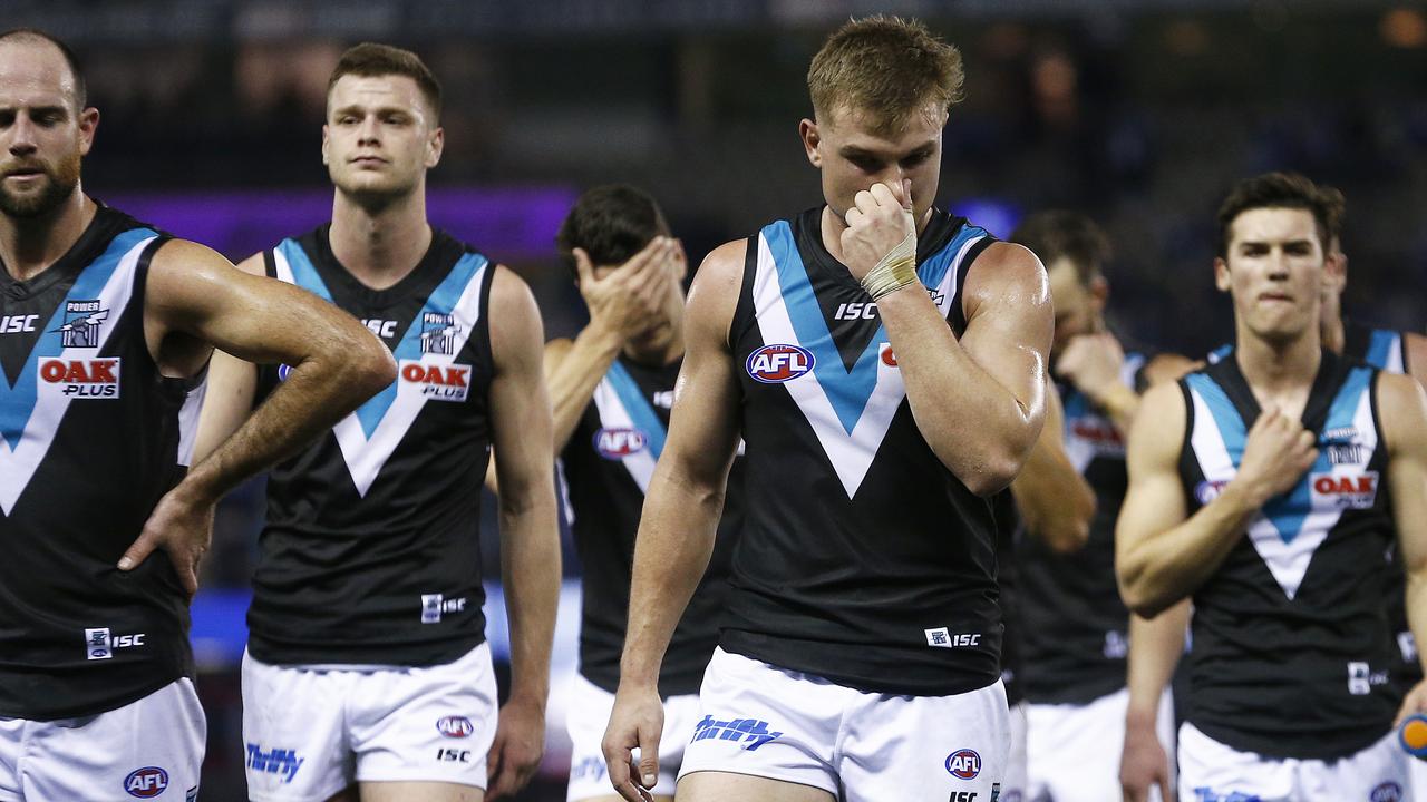 Power players look dejected after the loss to North Melbourne.