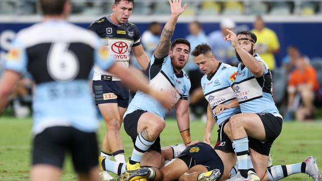 Sharks players call for help as North Queensland’s John Asiata lays injured on the Queensland Country Bank Stadium turf. Picture: AAP Image/Cameron Laird