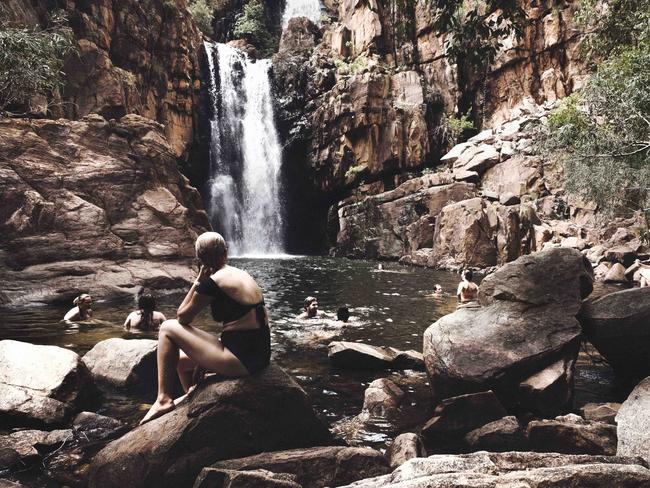 Kate Hulls is seen sitting on a rock at Southern Rockhole at Katherine Gorge. I have visited many of the TerritoryÕs natural wonders, but none have stayed with me like the Southern Rockhole at Katherine Gorge. We started our journey with a pleasant ferry ride along the gorge. As rocky walls met the blue sky, it was nothing short of spectacular. The ferry stopped at a sandy bank where we were told to follow a path which would take us to the rockhole. Streams of crystal clear water criss-crossed our path as we trekked towards the gorge. The walk is not a man-made path, and rock-hopping is required the majority of the way. We finally made it to the rockhole: a waterfall pounding into the water below, a pool into which swimming seemed irresistible. After swimming for some time, I felt the overwhelming need to close my eyes. As I lay on the rocks, the sound of laughter, moving water and bird call induced a light slumber. Gaining consciousness, I slowly opened my eyes to the beauty of dense, shimmering foliage, traversing all shades of green in the canopies above. Picture: Keri Megelus