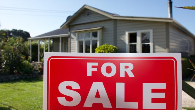 A For Sale Sign Outside a House.