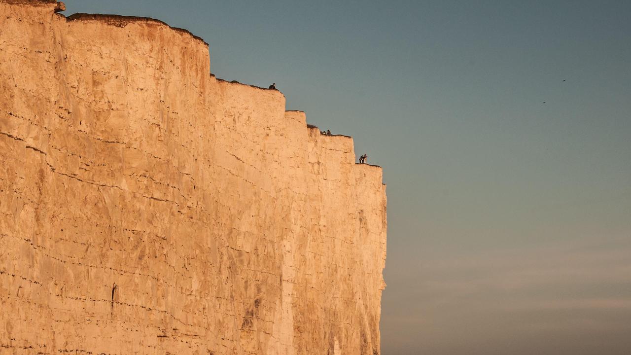 A cooler but bright day saw many enjoying the scenery on the Sussex coast. Some still do not seem to be aware of the fragility of the chalk cliff edge or are prepared to take a risk for the perfect picture. Picture: David Burr/Alamy Live News