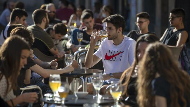 Customers drink on a terrace bar in Tarragona, Spain, on Monday. Picture: AP