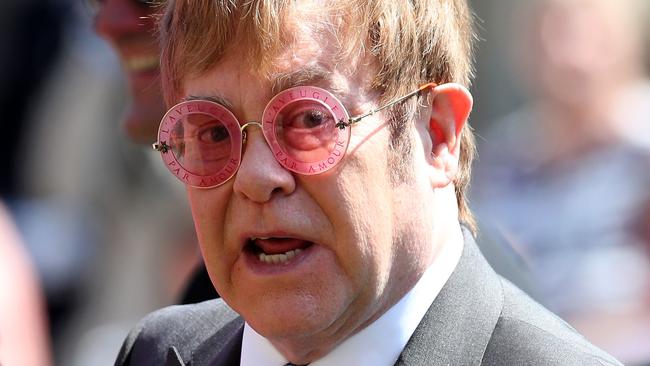 Elton John didn’t look impressed by the royal reverend’s sermon. Picture: Getty