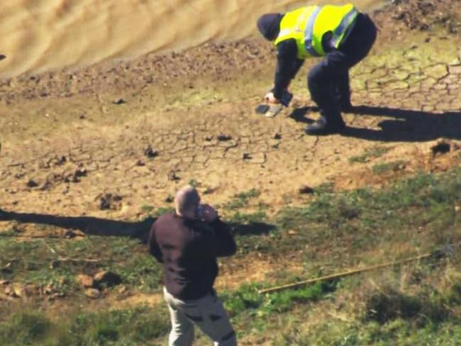 Police find items of interest at the dam. Picture: 9News