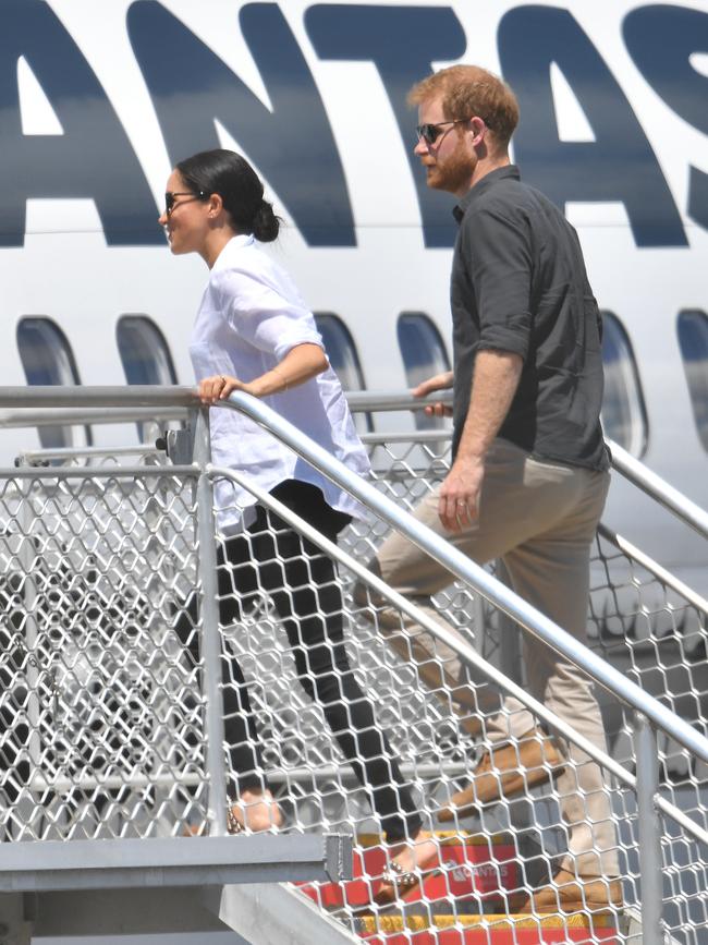 The royals board a plane in Hervey Bay in 2018. Even back then they were looking for paid jobs, the book claims.