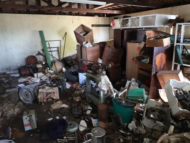 The once impressive mansion is now a magnet for “squatters, druggies and thieves”, with smashed windows, rotting timber and mounds of rubbish. Picture: Peter Wallis