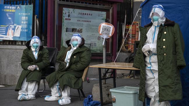 Epidemic control workers wear PPE to prevent the spread of COVID-19 as they guard in an area in lockdown in Beijing. Picture: Getty Images