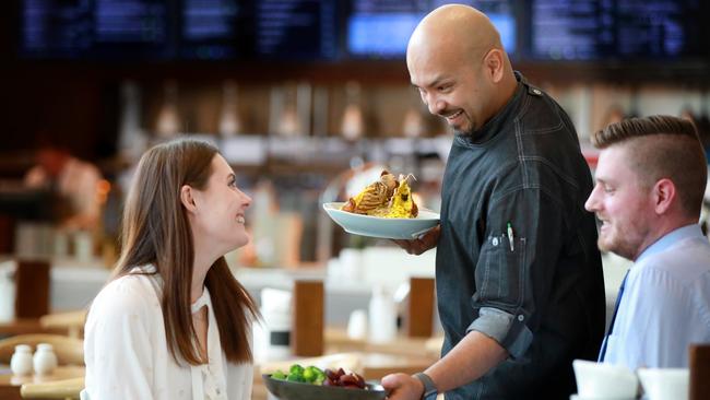 Executive chef Kamal Mudunkothge serves customer Katherine Angus at the cafe. Picture: Angelo Velardo