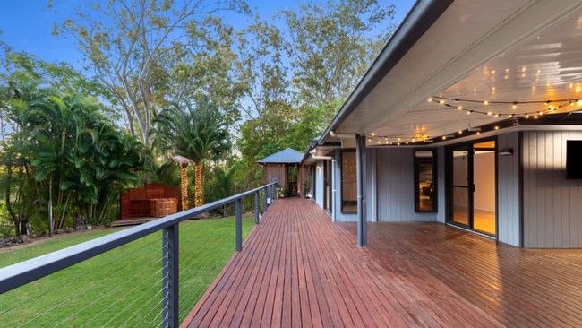 The homestead has a large balcony overlooking lush lawns and gardens.