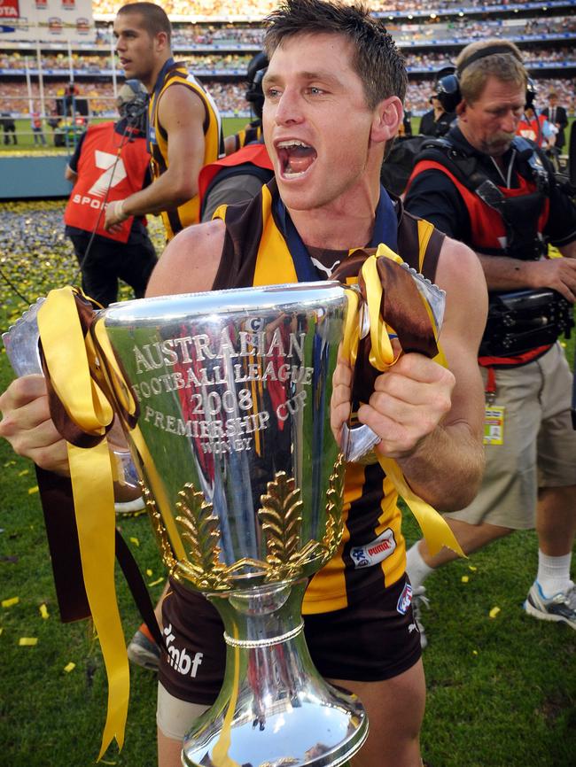 Shane Crawford celebrates with the premiership cup.