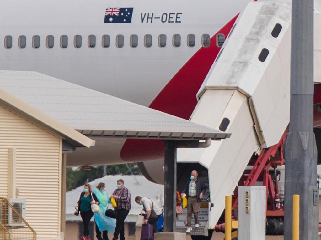 Australian evacuees from the coronavirus-struck cruise ship Diamond Princess deplane a Qantas flight from Japan at Darwin International Airport in Darwin, Thursday, February 20, 2020. Picture: Helen Orr/AAP