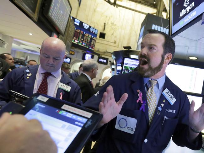Specialist Charles Boeddinghaus works with traders at the post that handles Allergan, on the floor of the New York Stock Exchange, Wednesday, April 6, 2016. The biggest U.S.-based drugmaker, Pfizer Inc., will stay put thanks to aggressive new Treasury Department rules that succeeded in blocking Pfizer from acquiring rival Allergan and moving to Ireland â€” at least on paper â€” to reduce its tax bill. (AP Photo/Richard Drew)