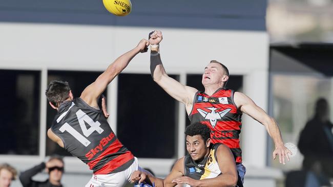 Lauderdale players Robbie McManus and Nicholas Raglione collide in the air over the top of Kingborough's Elijah Reardon. Picture: PATRICK GEE