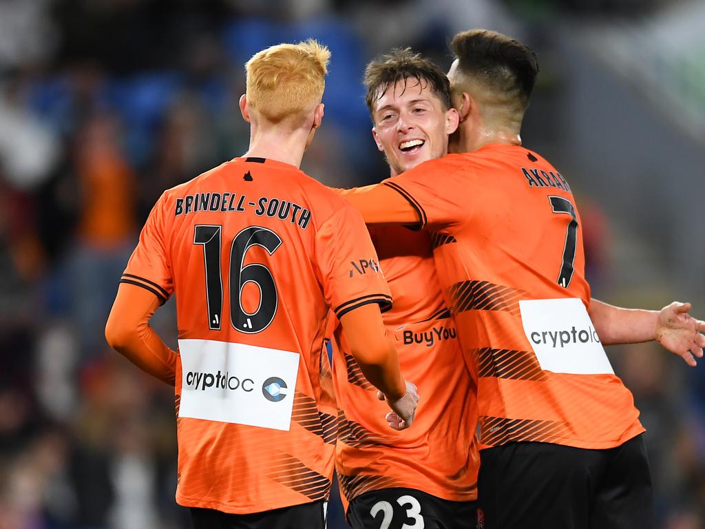 Joe Knowles (centre) is congratulated by Roar teammates after scoring against Leeds. Picture: Albert Perez/Getty Images