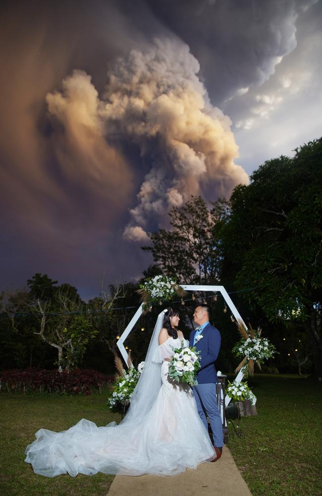 Kat Valfour and husband Chino who were married on Sunday with the Taal Volcano erupting in the background. Picture: Magnus