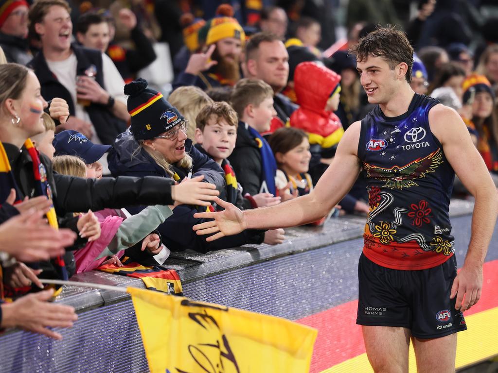 Billy Dowling celebrates the win against St Kilda with Crows fans. Picture: James Elsby/AFL Photos via Getty Images