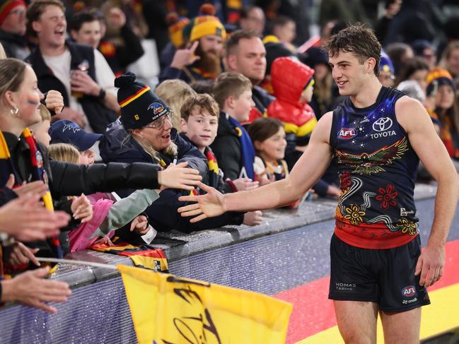 Billy Dowling celebrates the win against St Kilda with Crows fans. Picture: James Elsby/AFL Photos via Getty Images