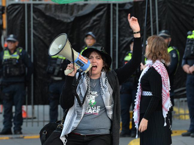 Deanna (Violet) Coco (with megaphone) protesting at Land Forces 2024 International Land Defence Exposition at Melbourne Exhibition and Convention Centre. Picture: Josie Hayden