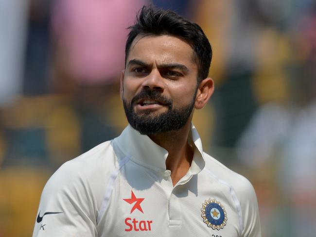 Indian captain Virat Kohli reacts as he walks back to the pavilion for tea break during the fourth day of the second Test match between India and Australia at The M. Chinnaswamy Stadium in Bangalore on March 7, 2017. / AFP PHOTO / Manjunath KIRAN / ----IMAGE RESTRICTED TO EDITORIAL USE - STRICTLY NO COMMERCIAL USE----- / GETTYOUT