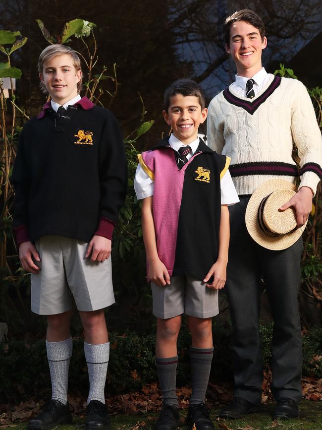 Harry Opray 16 in year 10, Jonni Marino 11 in grade 5, Harry Jones 17 in year 12 with old Hutchins uniforms and the school flag. The Hutchins School are celebrating their 175th birthday. Picture: Nikki Davis-Jones