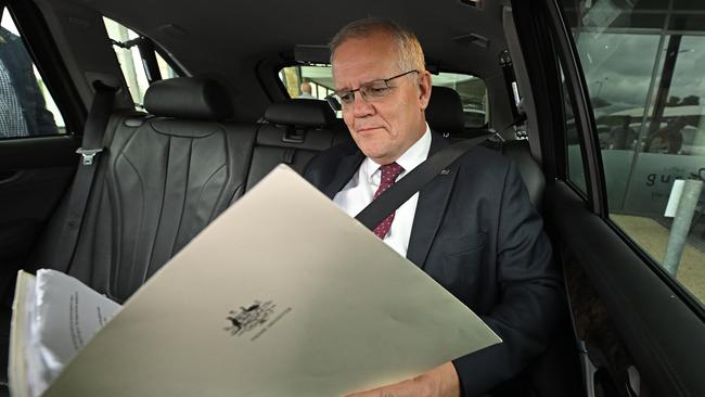 Scott Morrison catches up on some reading between campaign stops in Brisbane. Picture: Lyndon Mechielsen