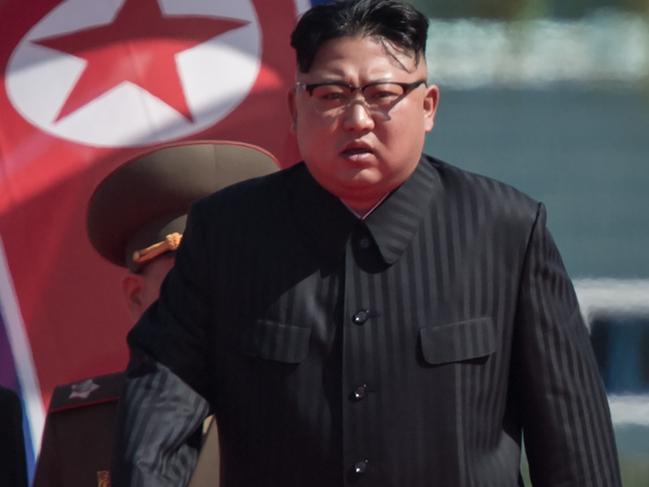 North Korean leader Kim Jong-Un (R) arrives flanked by vice-chairman of the State Affairs Commission Choe Yong-Hae (L) at an opening ceremony for 'Rymoyong street', a new housing development in Pyongyang, on April 13, 2017. With thousands of adoring North Koreans looking on -- along with invited international media -- Kim Jong-Un opened a prestige housing project as he seeks to burnish his nation's image even as concerns over its nuclear capabilities soar. / AFP PHOTO / ED JONES