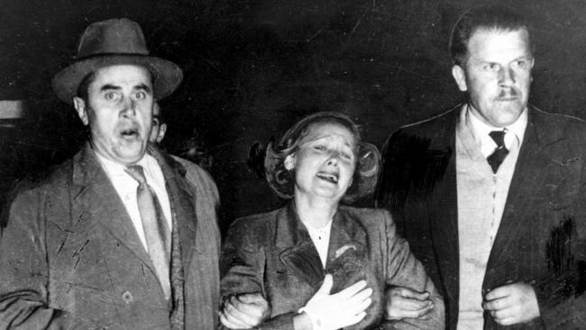 A distressed Evdokia Petrov being escorted onto a plane to Darwin, en route to the USSR, in April 1954 after her husband, Vladimir, defected. ASIO intervened at Darwin and she defected.