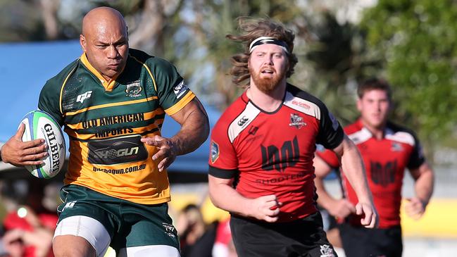 Pila Fifita (left) of Surfers Paradise Dolphins breaks free from a challenge by Chris Manby of Griffith College Knights during the Gold Coast District Rugby Union grand final played at the James Overall Park, Southport, Gold Coast. Photo: Regi Varghese