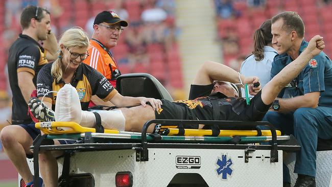 An injured Mitchell Graham for the Chiefs gives a dab to the crowd as he is carried off. Picture: Jono Searle.