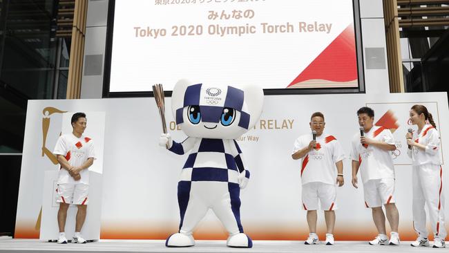 Miraitowa, the official mascot of the 2020 Summer Olympics, holds a torch during an event to unveil the Olympics torch relay route in Tokyo. Picture: Shinji Kita/Kyodo News via AP