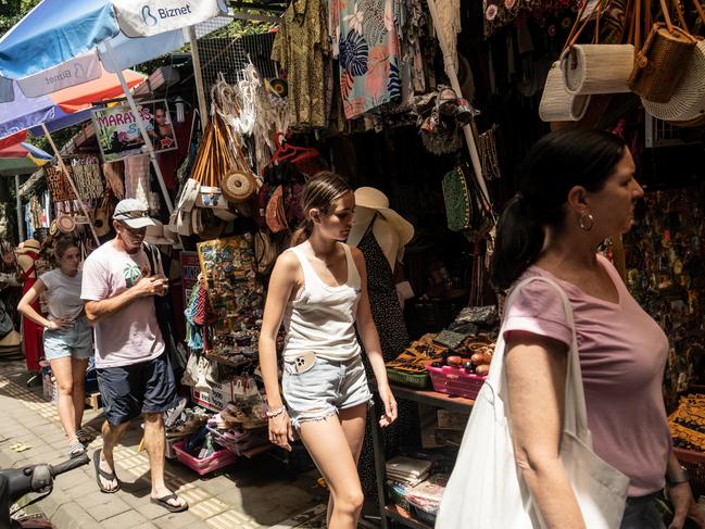 UBUD, BALI, INDONESIA - DECEMBER 8: Foreign tourists walk at the Ubud street art market on December 8, 2022 in Ubud, Bali, Indonesia. Indonesia's parliament voted to pass a law that bans extramarital sex on Tuesday, in a move that critics quoted in local media have said will severely impact the tourism industry. Regions like Bali rely heavily on an influx of foreign tourists to keep their economies afloat, and the new law has raised concerns just as international arrivals start to pick up again post-pandemic.  (Photo by Agung Parameswara/Getty Images)