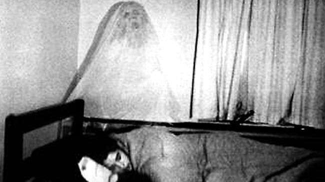 UNDATED : Generic photo of ghost in background as someone sleeps, undated.