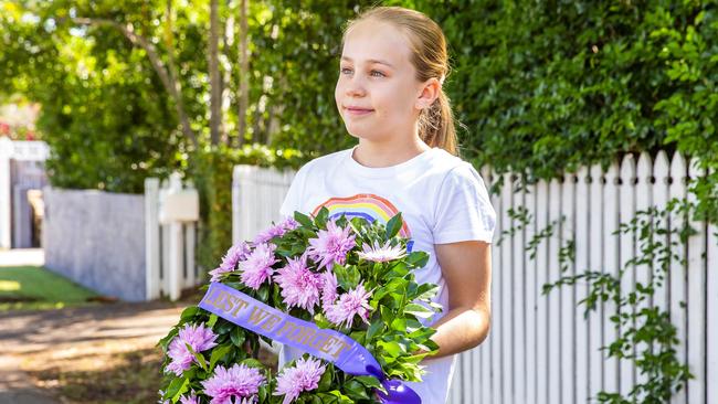 Lauren Jarrett, 11, of Hendra with a wreath she made for her school video memorial, using a wreath kit from Alba Roses. Picture: Richard Walker