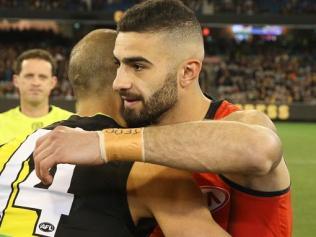 Adam Saad shares a hug with Bachar Houli.