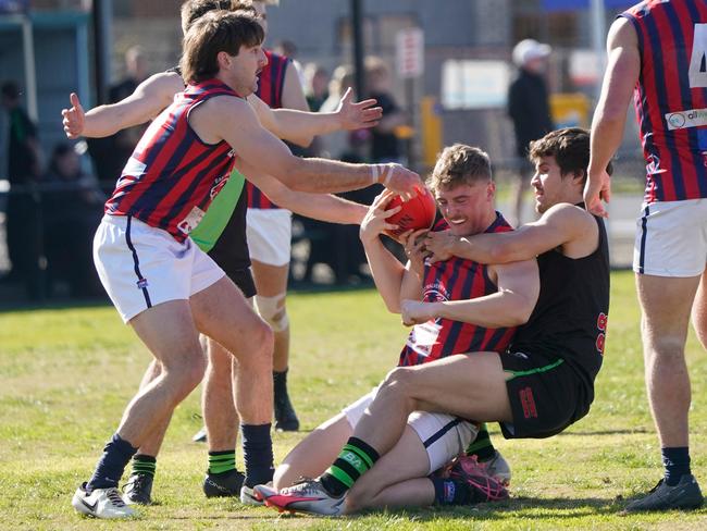 Logan Berryman fights off a strong tackle. Picture: Valeriu Campan