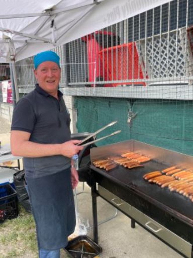 Barbecue volunteer Edward Easton at West End State School. Picture: Elliott Turner