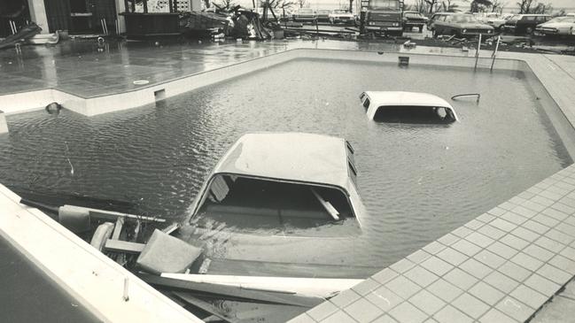 A famous Cyclone Tracy photograph depicts vehicles stranded in the Darwin TraveLodge Pool. Picture: Bob Seary