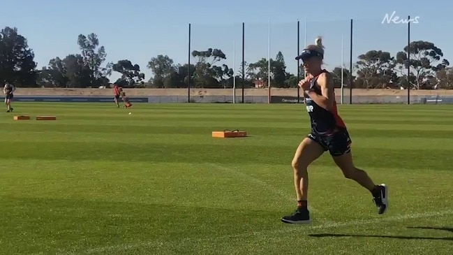 Erin Phillips runs on grass