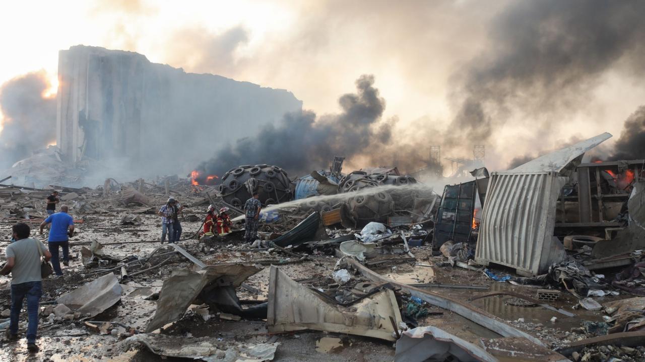 Firefighters extinguish flames at damaged buildings following the explosion. Picture: Hasan Shaaban/Bloomberg.