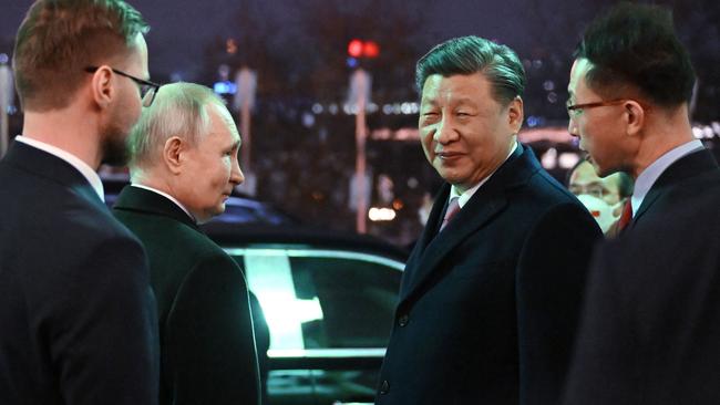 ‘Dear friends’: Vladimir Putin sees Xi Jinping to his car after the state dinner at the Kremlin on Tuesday. Picture: AFP