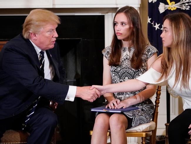 US President Donald Trump shakes hands with Marjory Stoneman Douglas High School student Ariana Klein, watched by fellow student Carson Abt. Picture: AFP/Mandel Ngan