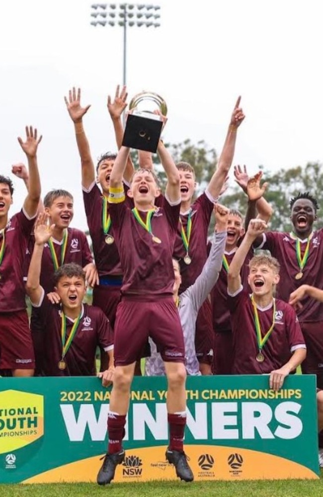 Rising Sunshine Coast football talent Rhys Williams lifts the trophy after his Queensland under-14 side took out the 2022 National Youth Football Championships. Picture: Contributed.