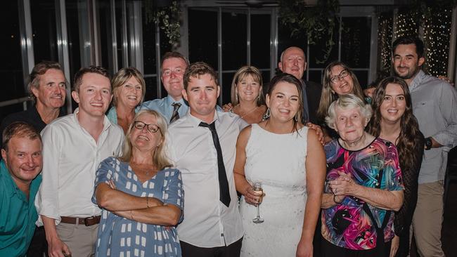 Tim Thompson (centre) surrounded by family including his wife Katie Thompson. The Woolgoolga man was tragically killed after being bitten by a shark while surfing near Emerald Beach.