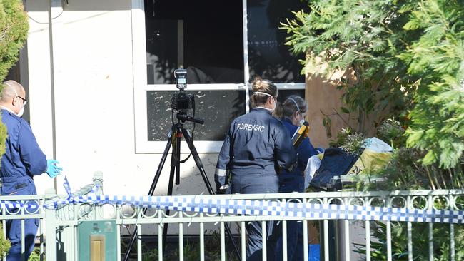 Forensic investigators scour the home on Binalong Ave. Picture: Josie Hayden