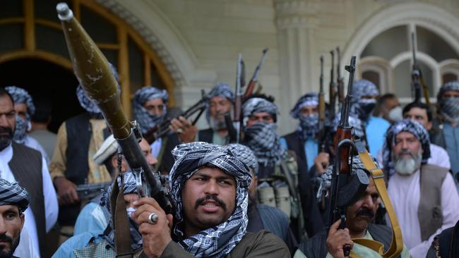 Afghan militia gather with their weapons to support Afghanistan security forces against the Taliban, in Afghan warlord and former Mujahideen Ismail Khan's house in Herat on July 9. Picture: AFP